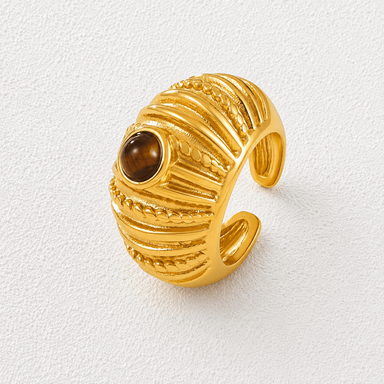 OJO DEL TEIDE · Anillo abierto acanalado en oro con ojo de tigre.