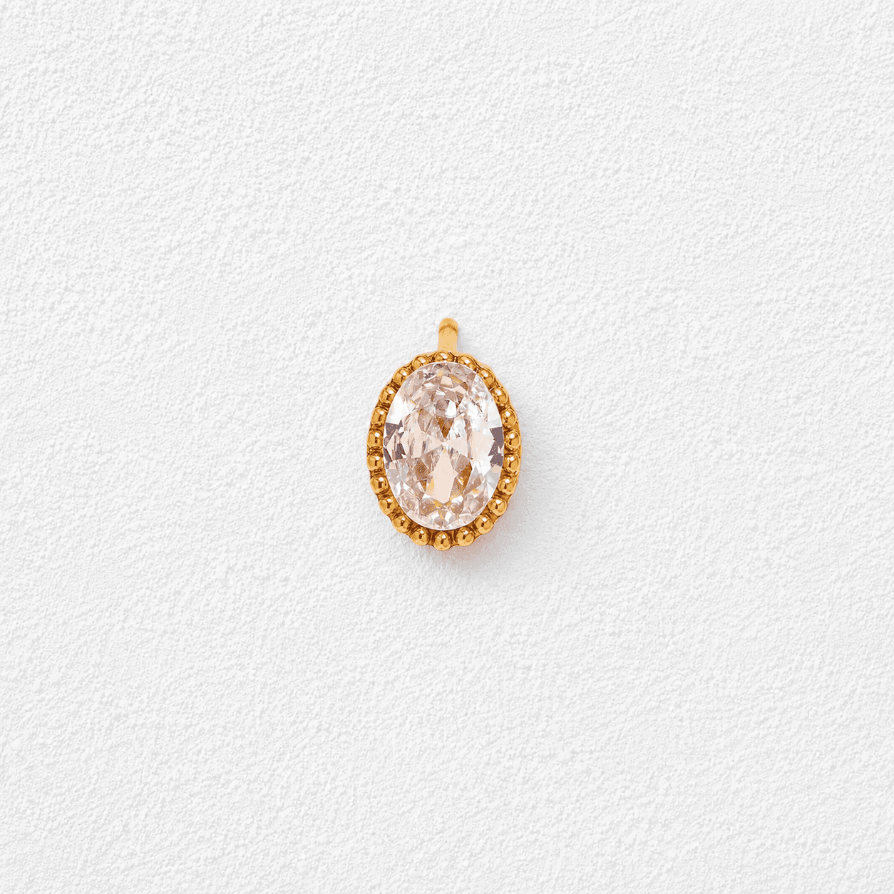 GOTA DE JANDÍA • Pendiente individual en oro con cristal ovalado facetado y orla de perlitas