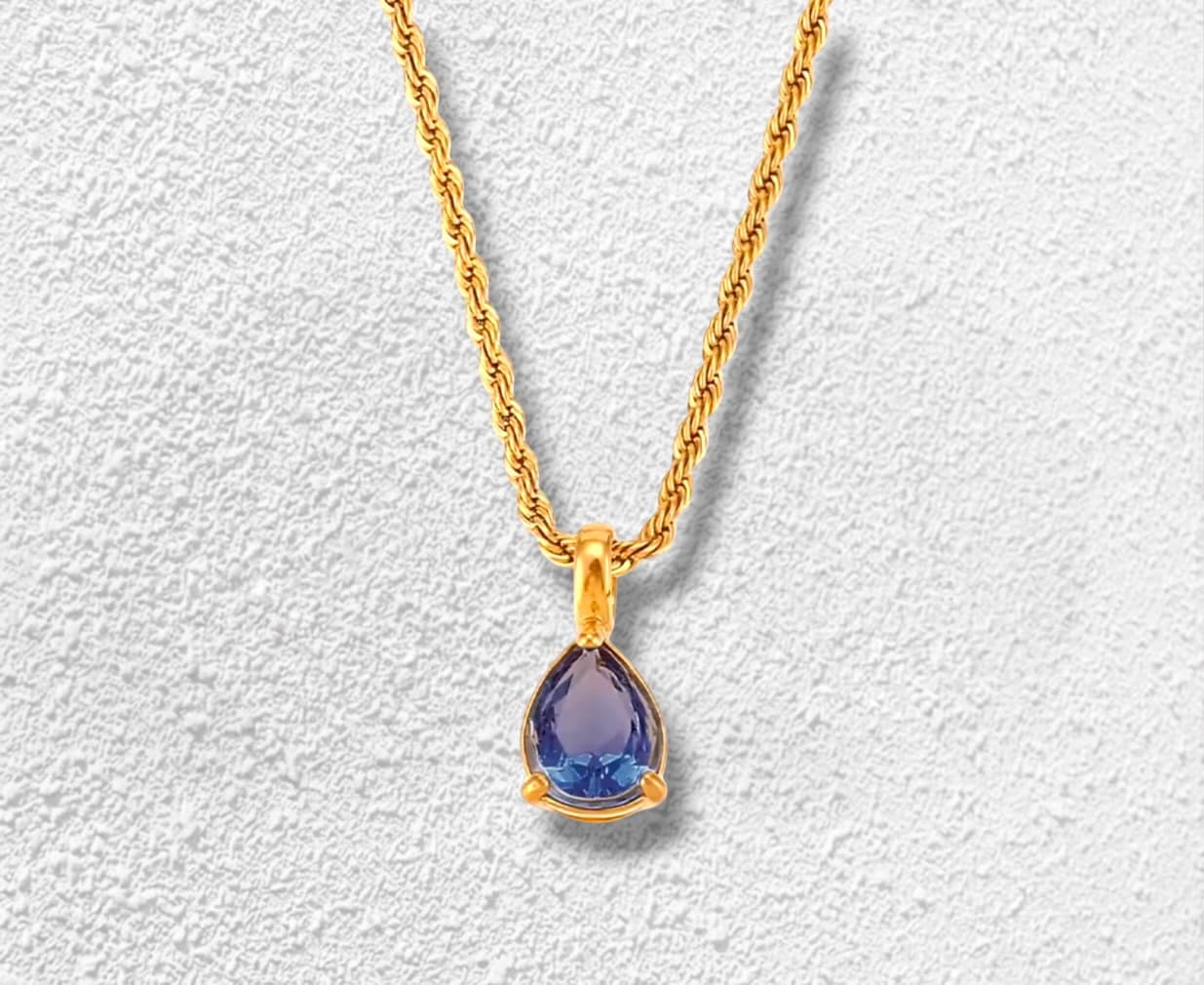 Primera Lluvia Collar · Cadena rope · Circonita pear cut azul · Montura garra