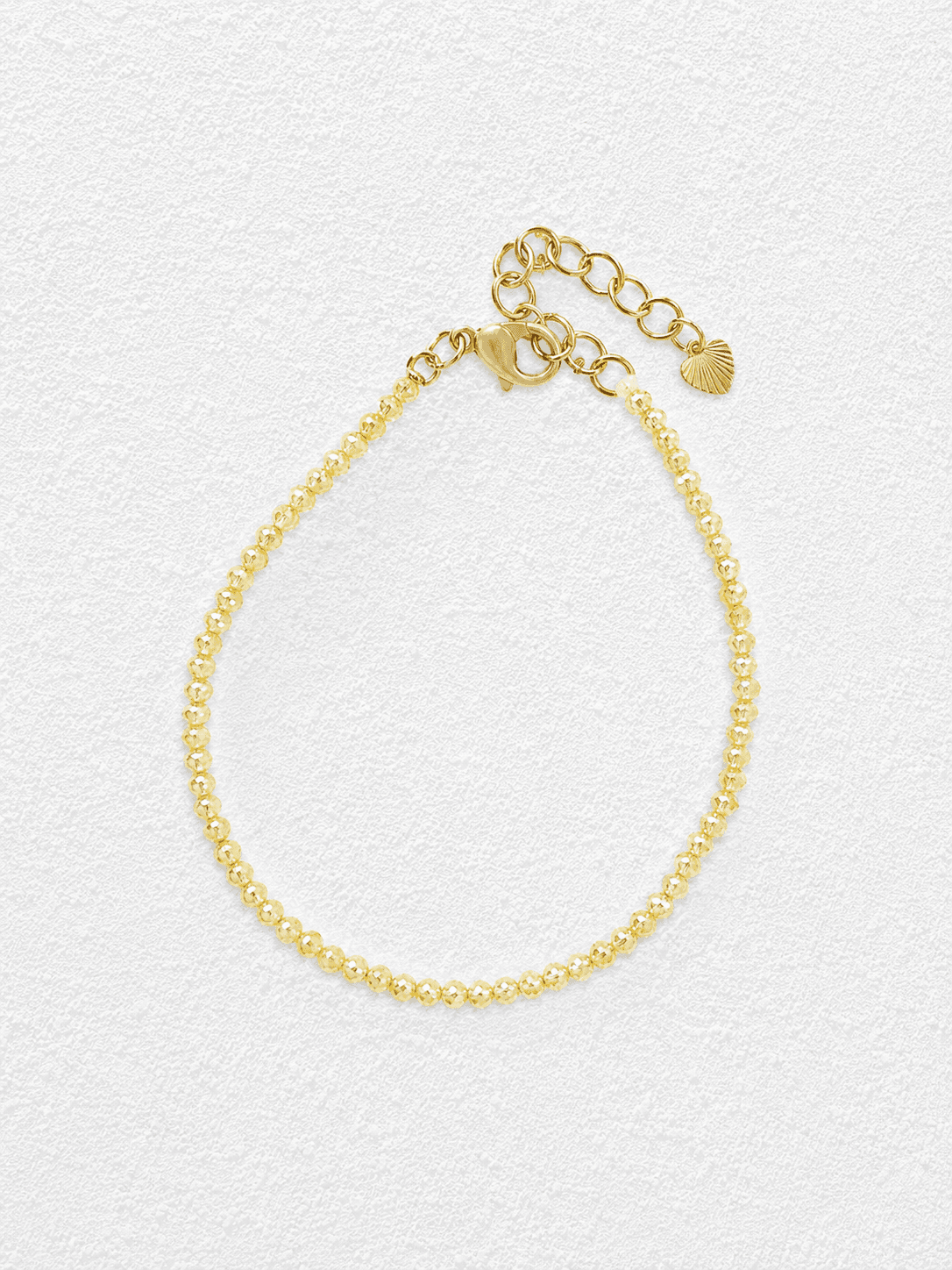 ARENA DE ORO · Pulsera de cuentas de cristal amarillo facetadas con cierre en forma de corazón.